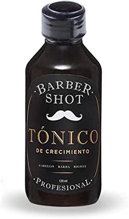 Una botella negra aparentemente de vidrio con una etiqueta que se lee 'Barber shot' 'Tónico de crecimiento' 'profesional'.